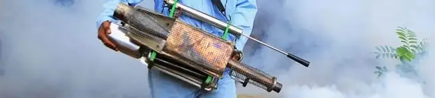 Fumigation technician using a fogger for deep pest treatment in Birmingham, AL
